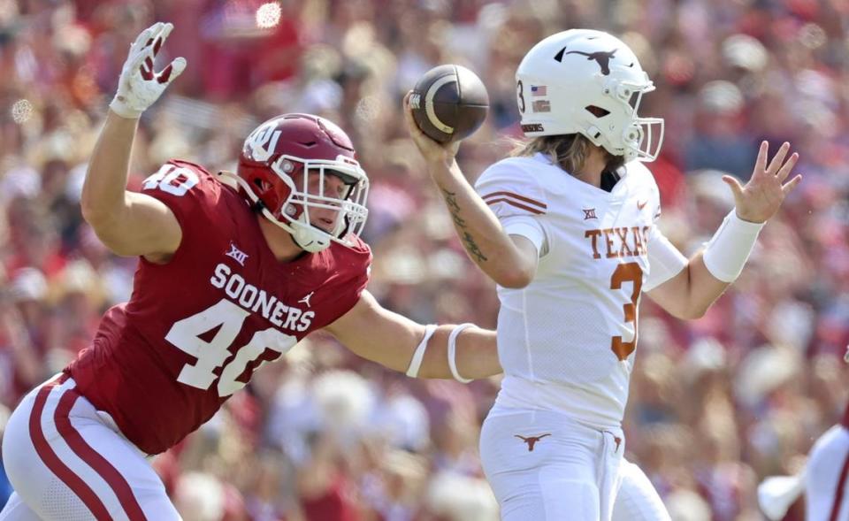 Texas quarterback Quinn Ewers (3) throws under pressure from Oklahoma defensive lineman Ethan Downs (40) during last year’s game at the Cotton Bowl. The Longhorns and Sooners will join the SEC next year.