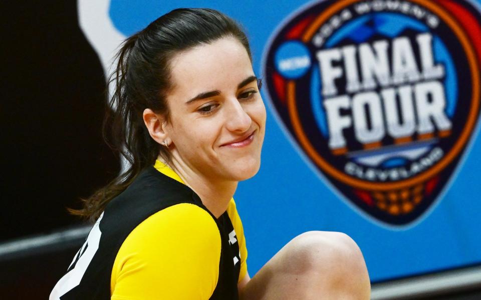 Iowa Hawkeyes guard Caitlin Clark (22) stretches during a practice session at Rocket Mortgage