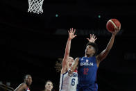 Serbia's Yvonne Anderson (12) drives to the basket over United States' Sue Bird (6) during women's basketball semifinal game at the 2020 Summer Olympics, Friday, Aug. 6, 2021, in Saitama, Japan. (AP Photo/Charlie Neibergall)