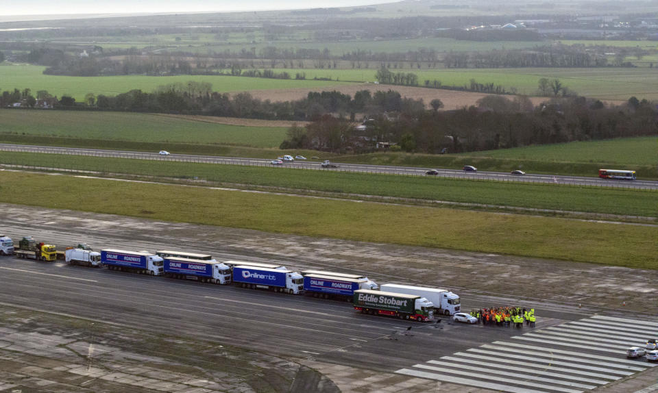 Some 150 trucks are parked at Manston Airfield during a test for a 'no-deal' Brexit, to assess where some 6,000 trucks could be parked at the derelict airfield near Ramsgate in south east England, Monday, Jan. 7, 2019. The former airfield at Manston could be used as part of the government plan to park some 6,000 trucks to alleviate expected congestion at the channel ports, about 25 miles (40 Km) from the airfiled, caused by the reintroduction of customs checks on goods in the event of Britain making a no-deal withdrawal from the European Union at the end of March. (Victoria Jones/PA via AP)