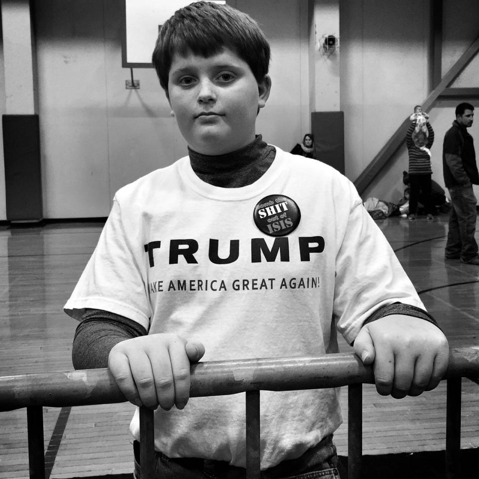 <p>Dillon Schmidt, 11, wears a “Bomb the shit out of ISIS” pin at a Trump rally on Jan. 26 in Iowa City, Iowa. (Photo: Holly Bailey/Yahoo News) </p>