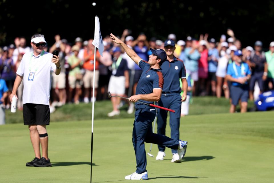 Hovland throws his ball to the crowd after fishing it from the hole (Getty Images)