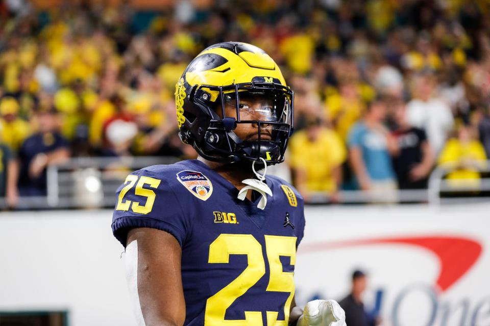 Michigan running back Hassan Haskins takes the field for warmups before the Orange Bowl against Georgia on Friday, Dec. 31, 2021, in Miami Gardens, Florida.