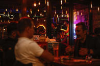 Musicians perform at a bar in Istanbul, Turkey, Friday, Oct. 23, 2020. In much of Europe, city squares and streets, be they wide, elegant boulevards like in Paris or cobblestoned alleys in Rome, serve as animated evening extensions of drawing rooms and living rooms. As Coronavirus restrictions once again put limitations on how we live and socialize, AP photographers across Europe delivered a snapshot of how Friday evening, the gateway to the weekend, looks and feels. (AP Photo/Emrah Gurel)