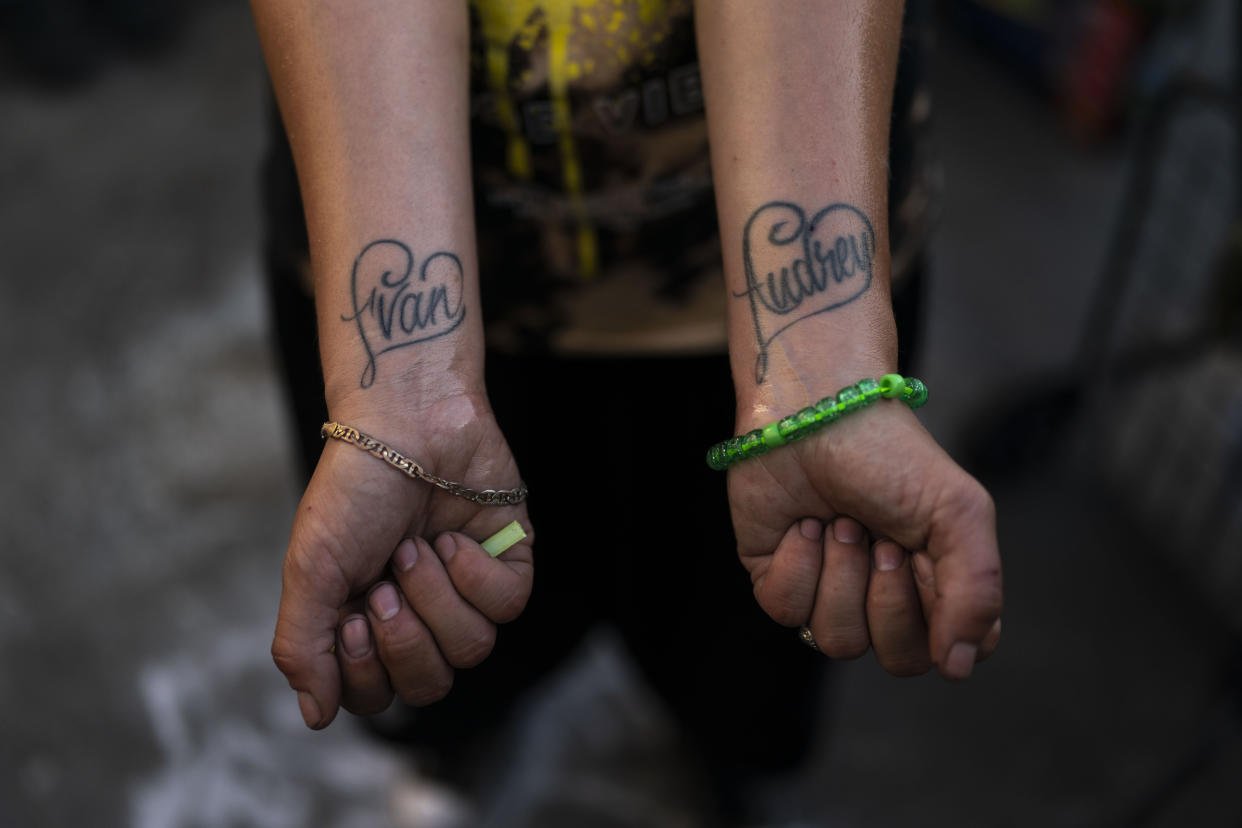 Jennifer Catano, a 27-year-old fentanyl addict, shows tattoos of the names of her two children, Evan and Audrey, in Los Angeles, Tuesday, Aug. 23, 2022. "My mom doesn't think it's a good idea because she thinks it's gonna hurt the kids because I'm not ready to get rehabilitated," said Catano who hasn't seen them for several years. (AP Photo/Jae C. Hong)