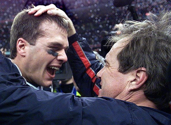 NEW ORLEANS, UNITED STATES:  New England Patriots' quarterback Tom Brady celebrates with head coach Bill Belichick (R) after their win over the St. Louis Rams 03 February, 2002 in Super Bowl XXXVI in New Orleans, Louisiana. The Patriots defeated the Rams 20-17 for the NFL championship. AFP PHOTO/Jeff HAYNES (Photo credit should read JEFF HAYNES/AFP via Getty Images)