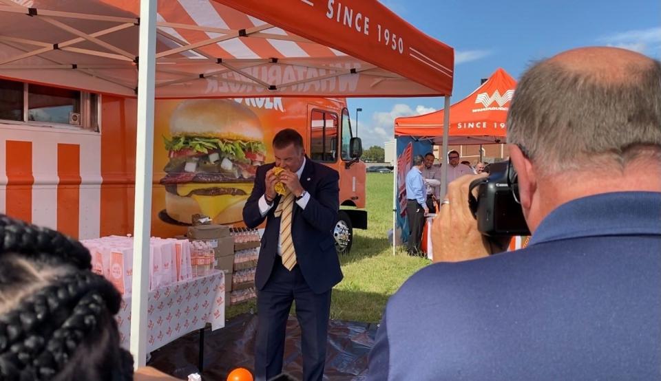 Mayor Darren Musselwhite takes the first bite of a Whataburger burger at the groundbreaking in Southhaven on Monday, Oct. 4, 2021. The first Whataburger in DeSoto County will open in early 2022.