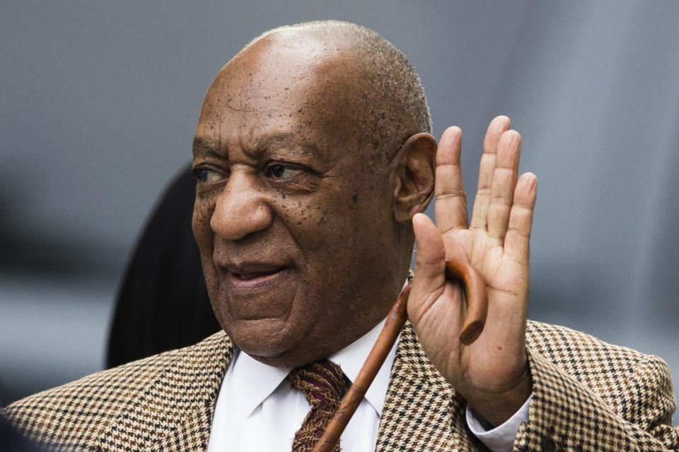 Bill Cosby waves as he arrives for a pretrial hearing in his sexual assault case at the Montgomery County Courthouse in Norristown, Pa., Tuesday, Dec. 13, 2016. Lawyers for Cosby will battle in court to try to limit the number of other accusers who can testify at the comedian's sexual assault trial. (AP Photo/Matt Rourke)