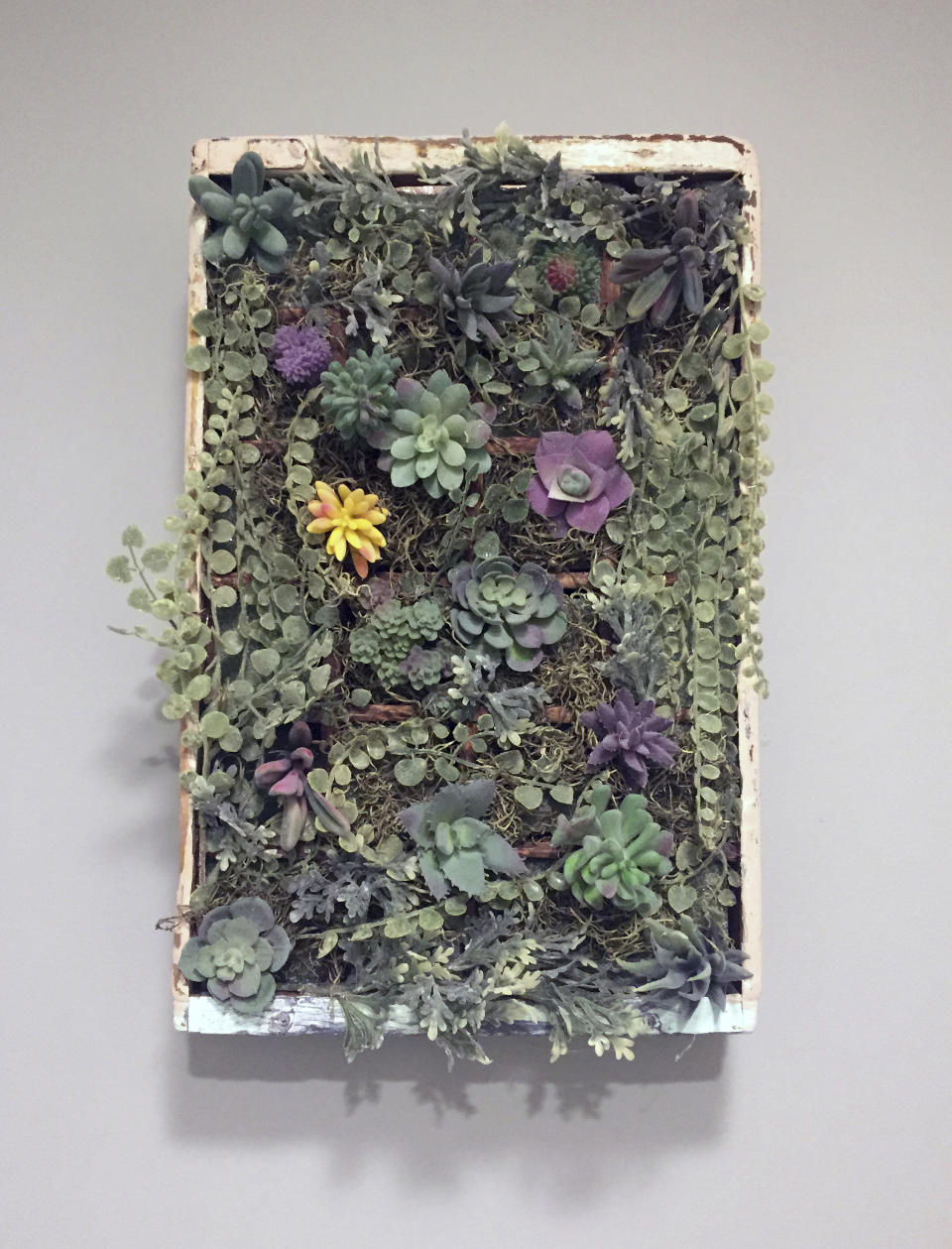 Ashley Martin, a teacher and part time crafter in Green Township, N.J., created this display out of a scrounged wooden soda bottle crate and a collection of succulents. Martin says she's always loved doing arts and crafts projects, but she really became obsessed with cottagecore décor when she and her husband bought an 1850s farmhouse. Turning her ideas into custom art and signs became a side gig for her, and she's busy working on orders for the holidays now. I really enjoy working on something creative any time that I can. For me, it's an outlet." (Ashely Martin via AP)