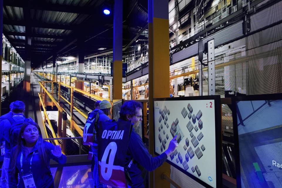 People play a pallet packing game at the Walmart booth during the CES tech show Tuesday, Jan. 9, 2024, in Las Vegas. (AP Photo/John Locher)