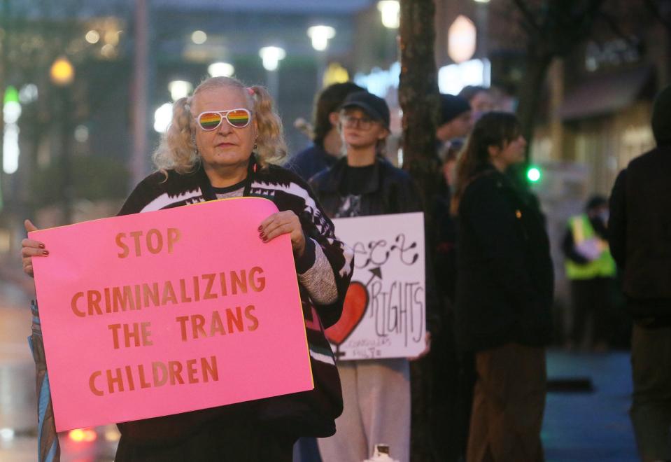 Anntoinette Baker, 63 protests during a rally for trans rights at the Highland Square Branch Library on West Market Street in Akron on Wednesday. The Ohio Senate voted to override the governor's veto of House Bill 68, which will restrict gender-affirming care for minors.