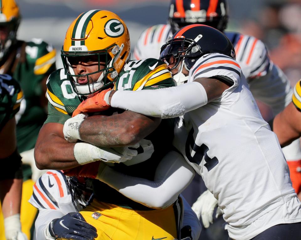 Green Bay Packers running back A.J. Dillon (28) runs for a gain through a tackling Chicago Bears free safety Eddie Jackson (4) during the fourth quarter of the Green Bay Packers 24-14 win at Soldier Field in Chicago on Sunday, Oct. 17, 2021.  -  Photo by Mike De Sisti / Milwaukee Journal Sentinel via USA TODAY NETWORK