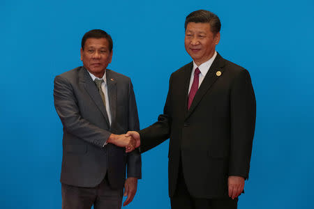 FILE PHOTO: Chinese President Xi Jinping shakes hands with Philippine President Rodrigo Duterte as they attend the welcome ceremony at Yanqi Lake during the Belt and Road Forum, in Beijing, China, May 15, 2017. REUTERS/Roman Pilipey/Pool