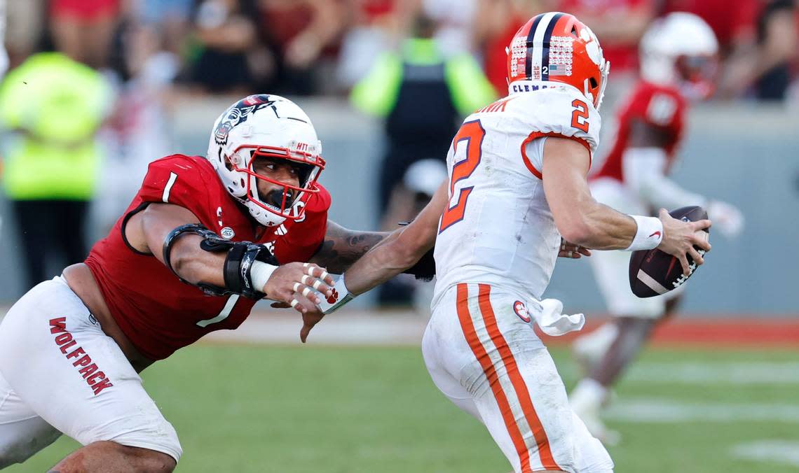 N.C. State defensive tackle Davin Vann (1) chases down Clemson quarterback Cade Klubnik (2) to sack him late in the second half of N.C. State’s 24-17 victory over Clemson at Carter-Finley Stadium in Raleigh, N.C., Saturday, Oct. 28, 2023. Ethan Hyman/ehyman@newsobserver.com