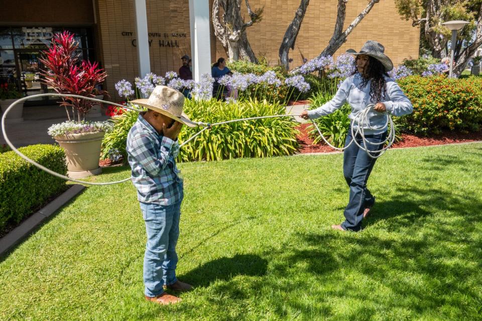 Juliana Peralta practices her roping on friend Julian Martinez