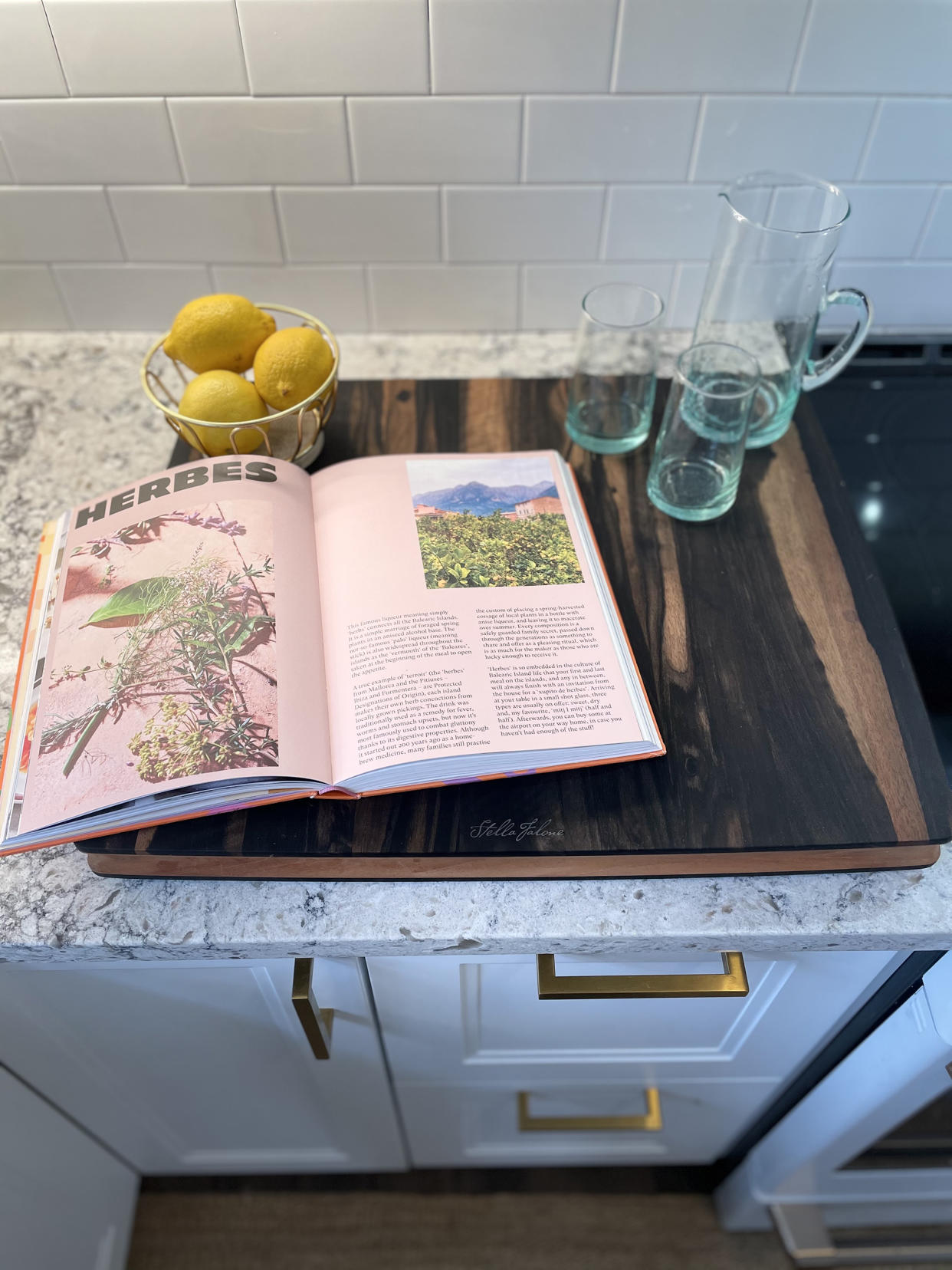 An ebony cutting board made from leftover Taylor guitar parts, a cookbook I found on a memorable day in Brooklyn and handmade Moroccan glassware from Revival helped create warm, personal touches in a clean, modern kitchen. (Erica Chayes Wida)