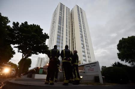 Firefighters stand outside the Burnham Tower residential block, as residents were evacuated as a precautionary measure following concerns over the type of cladding used on the outside of the building on the Chalcots Estate in north London, Britain, June 24, 2017. REUTERS/Hannah McKay