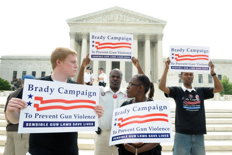 Pro-gun control protesters hold signs in front of the Supreme Court in Washington as they wait for the court's decision on the D.C. handgun ban on June 26, 2008. The Supreme Court, in a 5-4 ruling, struck down Washington's handgun ban, affirming the rights of individuals to own firearms. File Photo by Roger L. Wollenberg/UPI