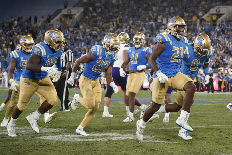 UCLA linebacker JonJon Vaughns (21) celebrates after intercepting a pass from Washington quarterback Michael Penix Jr. during the first half of an NCAA college football game Friday, Sept. 30, 2022, in Pasadena, Calif. (AP Photo/Marcio Jose Sanchez)