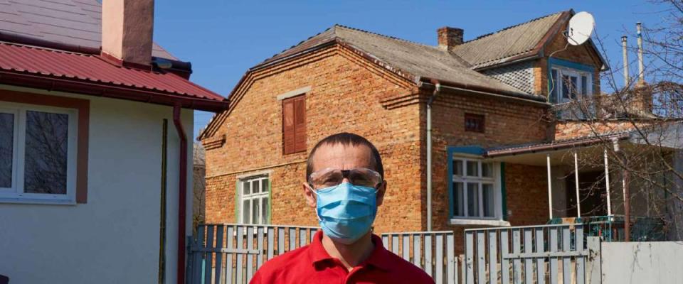 man in medical mask in the yard,man standing in his yard in summer wearing a protective mask and goggles
