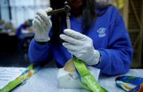 A worker from the Casa da Moeda do Brasil (Brazilian Mint) prepares Rio 2016 Olympic medals in Rio de Janeiro, Brazil, June 28, 2016. REUTERS/Sergio Moraes