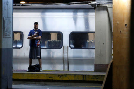 A morning commuter waits on the the platform at New York's Pennsylvania Station which began track repairs causing massive disruptions to commuters in New York City, U.S., July 10, 2017. REUTERS/Brendan McDermid