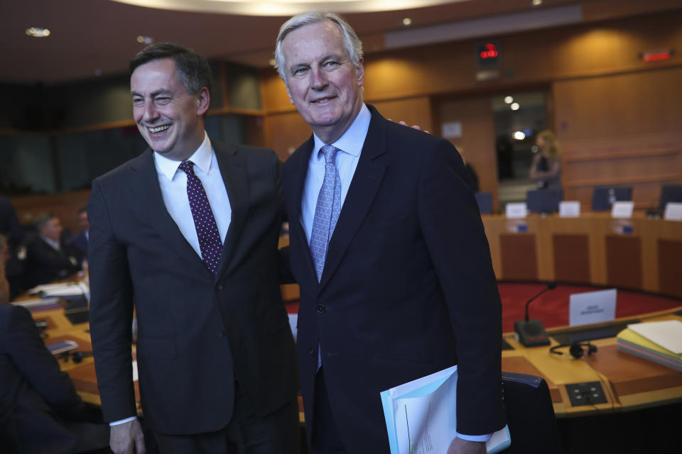 FILE - In this Wednesday, Feb. 5, 2020 file photo, European Commission's Head of Task Force for Relations with the United Kingdom Michel Barnier, right, is greeted by David McAllister, the German EU parliamentarian who is the legislature's top official on the bilateral relations. Slowed by the coronavirus pandemic and whipped up by a British-imposed deadline, talks between the EU and the UK on a future relationship in the wake of Brexit are struggling to make significant progress. A third negotiation session is drawing to a close on Friday, May 15, 2020 but so far, just over 100 days after the official exit of the UK from the EU, fundamental gaps still exist. (AP Photo/Francisco Seco, File)