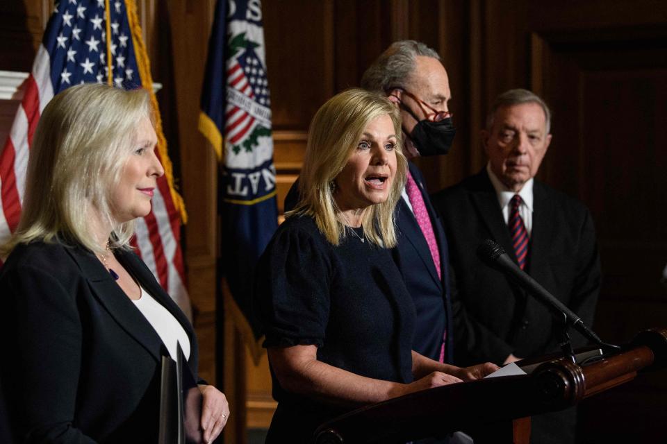 Former Fox News anchor Gretchen Carlson (2nd L) speaks at a press conference to mark the passage of the Ending Forced Arbitration of Sexual Assault and Sexual Harassment Act alongside Democratic Senator from New York Kirsten Gillibrand (L), Senate Majority Leader Chuck Schumer (2nd R) and Democratic Senator from Illinois Dick Durbin at the US Capitol in Washington, DC, on February 10, 2022.