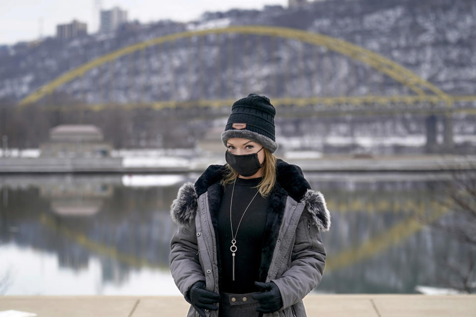 In this photo made on Monday, Feb. 8, 2021, Allissa Star poses for a photograph along the north shore of the Allegheny River in Pittsburgh. Starr worked about a week every month at a brothel in Pahrump, Nev., outside of Las Vegas. Then the pandemic led to the shuttering of Nevada's licensed bordellos, the only place where prostitution is legal in the state, and they have remained closed since March, leaving sex workers like Starr struggling to pay the bills and turning to alternatives like "virtual" dates. (AP Photo/Keith Srakocic)