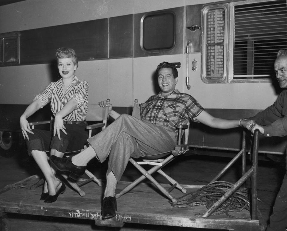 <p>The couple flashes their camera-ready smiles as they relax outside of their trailer on set. This same year, the couple launched their joint production company, Desilu Productions<em>. </em></p>