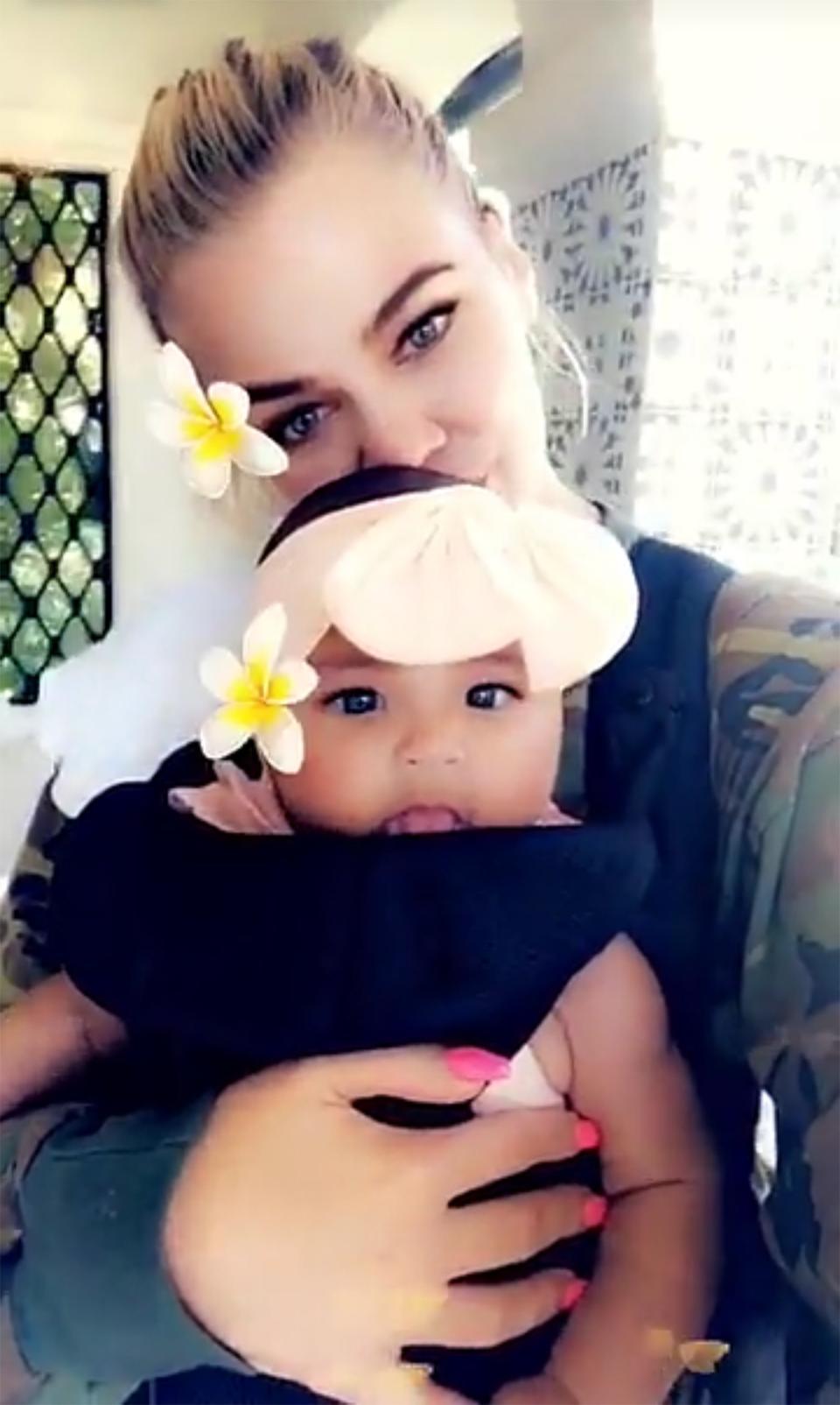 In a series of clips shared to <a href="https://people.com/tag/khloe-kardashian/" rel="nofollow noopener" target="_blank" data-ylk="slk:Khloé;elm:context_link;itc:0;sec:content-canvas" class="link ">Khloé</a>‘s Snapchat account, the reality star’s 4-month-old baby girl was resting snugly in front of her mama in a <a href="https://www.amazon.com/s/ref=nb_sb_noss_2?url=search-alias=aps&field-keywords=babybjorn+carrier&rh=i:aps,k:babybjorn+carrier" rel="nofollow noopener" target="_blank" data-ylk="slk:carrier by Babybjörn;elm:context_link;itc:0;sec:content-canvas" class="link ">carrier by Babybjörn</a>.