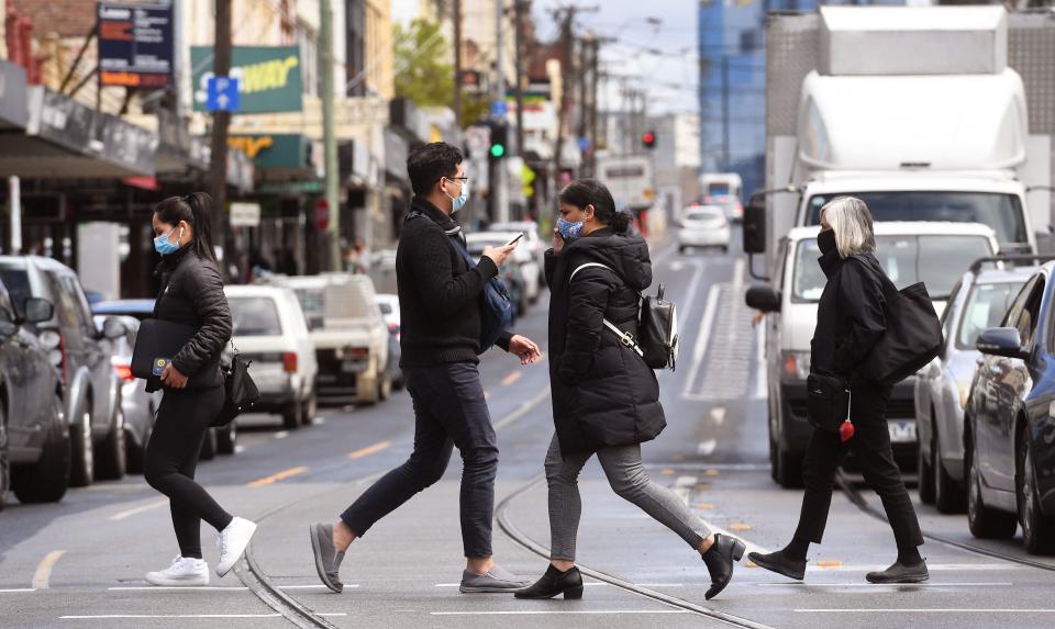 People cross a city street. (Source: Getty)