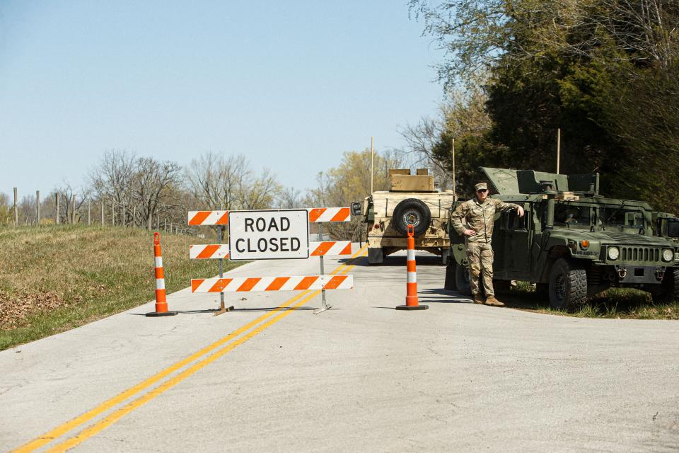 Military personnel cordon off maple grove road which leads to the location of where a black hawk crashed, killing nine soldiers, early in the morning in Trigg County, KY on Mar. 30, 2023.