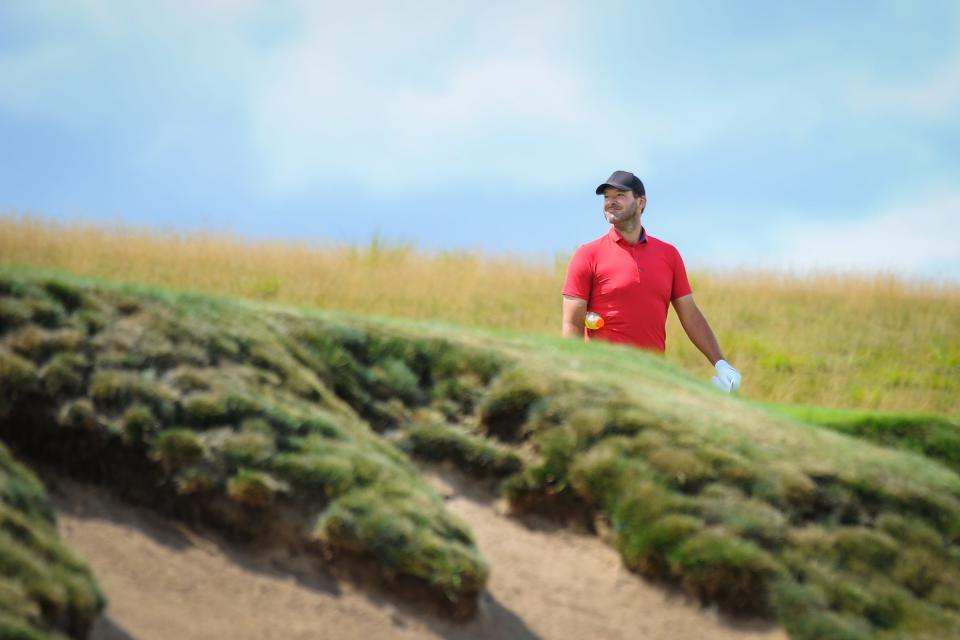 Tony Romo sizes up a shot on the first hole during the first round of the 122nd Wisconsin State Amateur Championship on Monday, July 17, 2023, at Erin Hills Golf Course in the Town of Erin, Wisconsin.