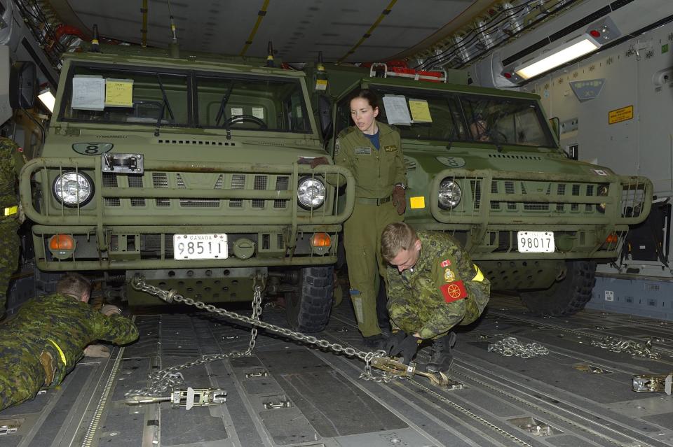 The advance party of the Disaster Assistance Response Team (DART) loads vehicles on a C177 Globemaster bound for Hawaii at Canadian Forces Base Trenton