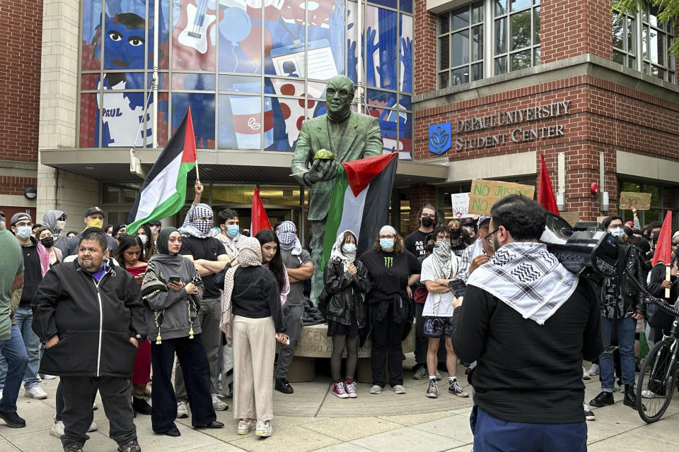 Antiwar protesters rallied at DePaul University in Chicago, Thursday evening, May 16, 2024, after an encampment at the campus quad had been taken down by university police early in the morning. (AP Photo/Melissa Perez Winder)