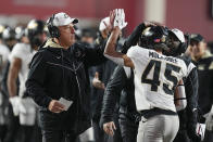 Purdue head coach Jeff Brohm, left, celebrates with Devin Mockobee (45) after Mockobee ran for a touchdown during the second half of an NCAA college football game against Indiana, Saturday, Nov. 26, 2022, in Bloomington, Ind. (AP Photo/Darron Cummings)