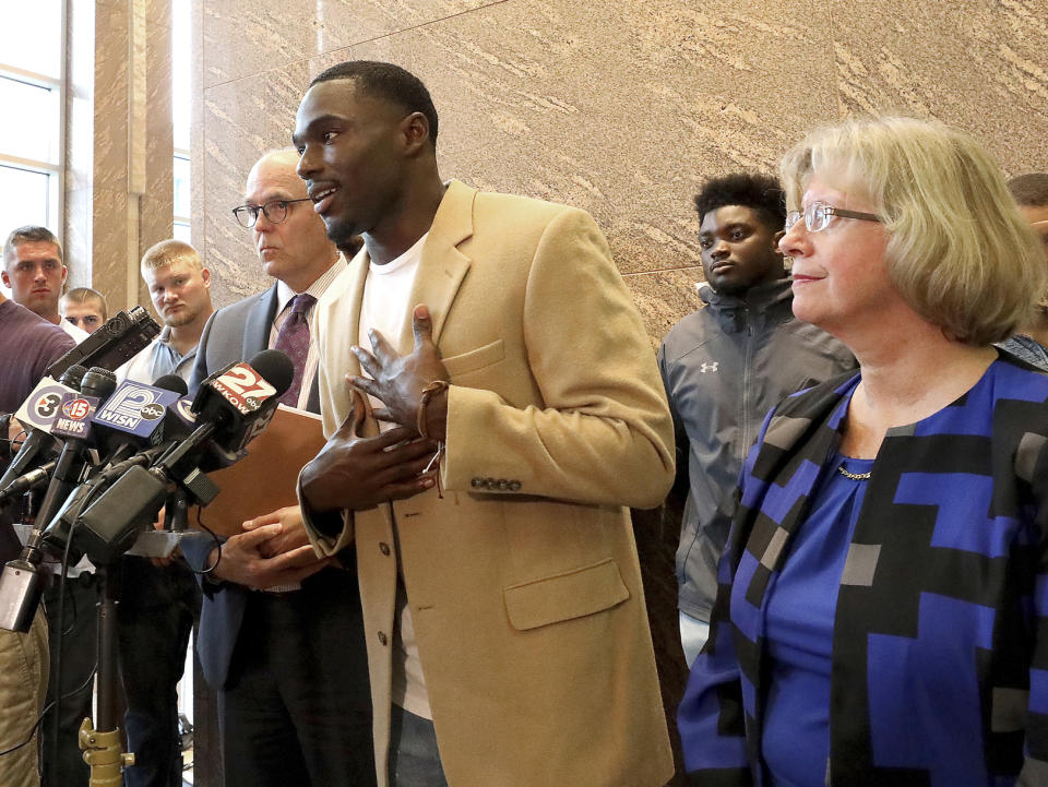 Former Wisconsin Badger football player Quintez Cephus speaks during a press conference to reiterate his request for reinstatement to the university in Madison, Wis. Monday, Aug. 12, 2019. The former wide receiver was acquitted earlier this month of sexual assault charges stemming from a campus incident in his apartment. He was expelled from the university in March after the university's own internal investigation. He is pictured with his attorneys, Stephen Meyer and Kathleen Stilling, as well as a group of current team members were on hand to show support for Cephus at the event. (John Hart/Wisconsin State Journal via AP)