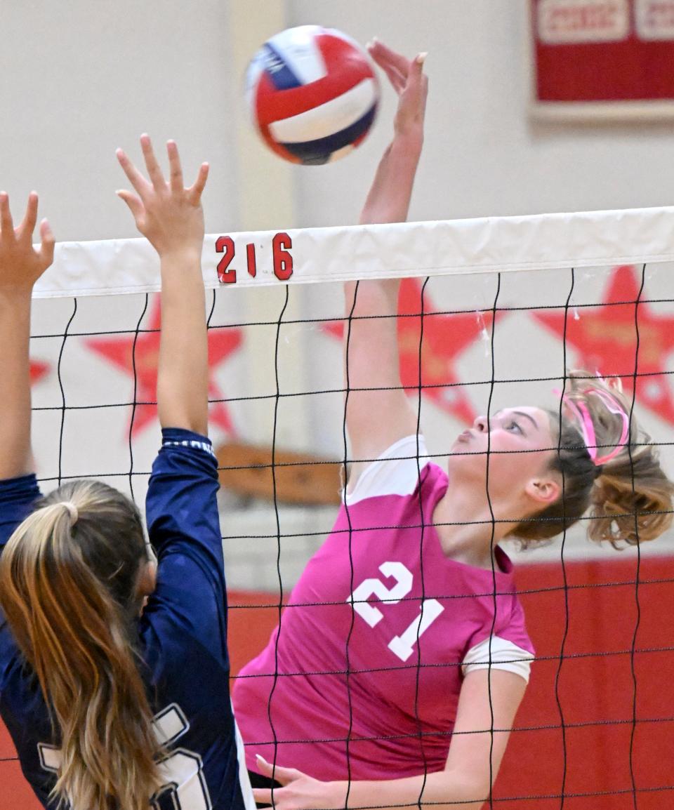 Molly Fredo of Barnstable spikes the ball past Grace Loewen of Sandwich in an October 2022 game in Hyannis.
