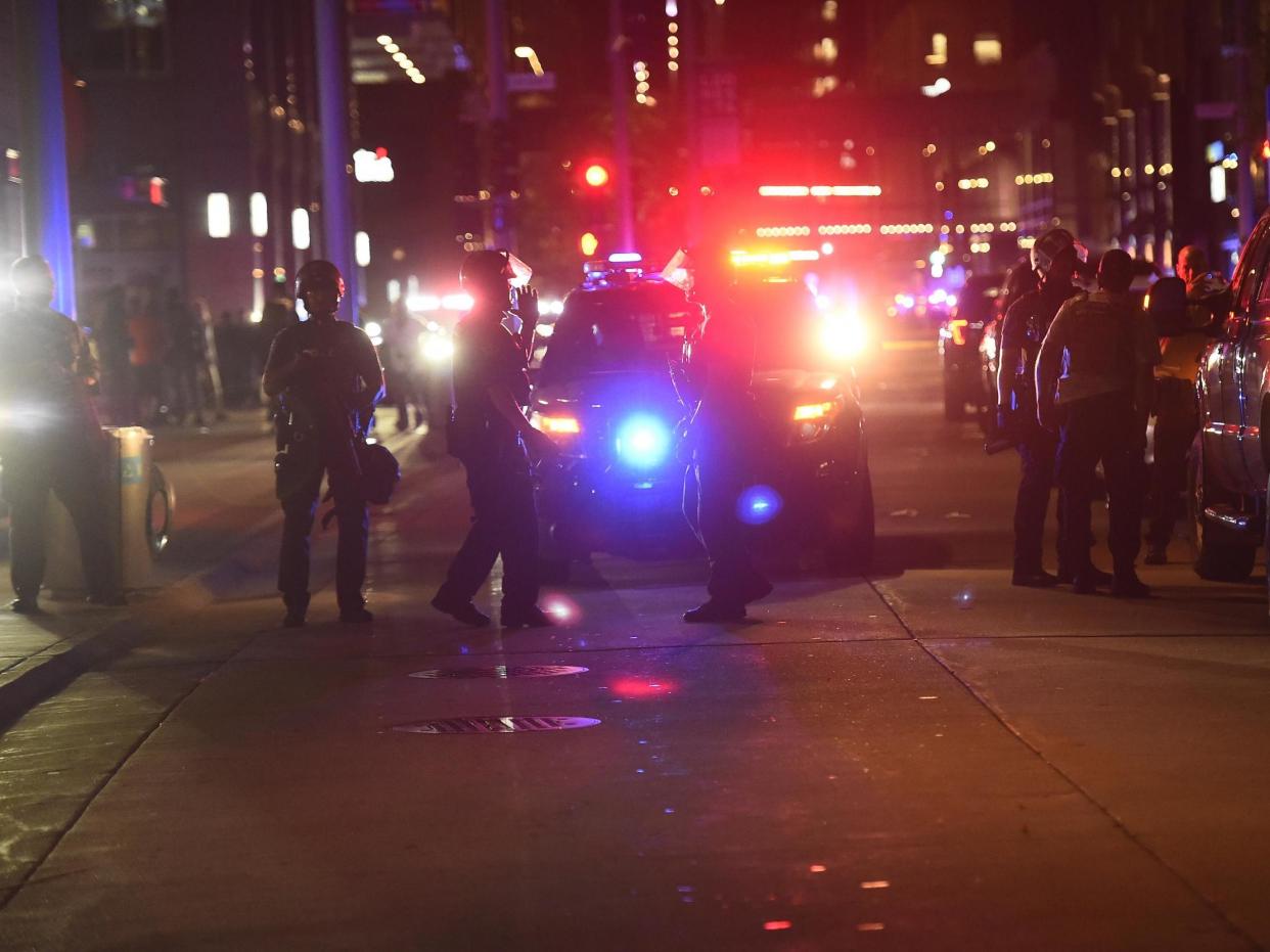 Police officers stand guard as protesters and rioters clash with police after a homicide suspect killed himself as police closed in on him in downtown Minneapolis, Minnesota, USA, 26 August 2020: (EPA)