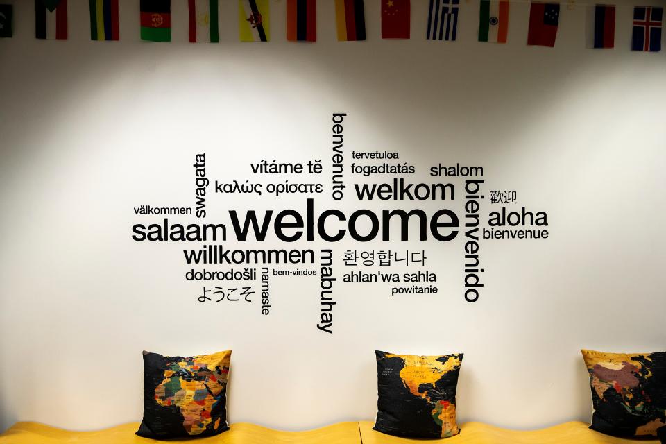 A wall graphic featuring the world welcome in different languages is seen, Monday, Dec. 5, 2022, at Phillips Hall on the University of Iowa campus in Iowa City, Iowa.