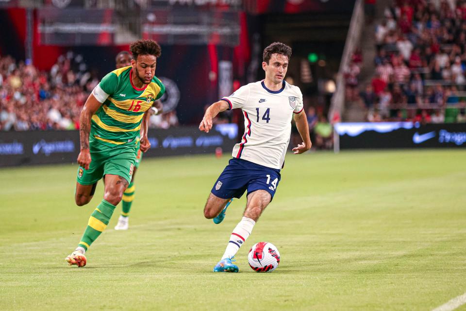 United States midfielder Luca de la Torre (14) is chased by Grenada defender Arthur Paterson (16) during the match at Q2 Stadium in Austin, Texas on June 10, 2022.