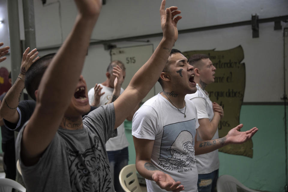 Prisoners pray during an evangelical service at the Correctional Institute Model U.1., Dr. Cesar R Tabares, known as Penitentiary Unit 1, in Coronda, Santa Fe province, Argentina, Friday, Nov. 19, 2021. At Penal Unit No. 1 in Coronda, the day in the evangelical units begins and ends with prayer. (AP Photo/Rodrigo Abd)