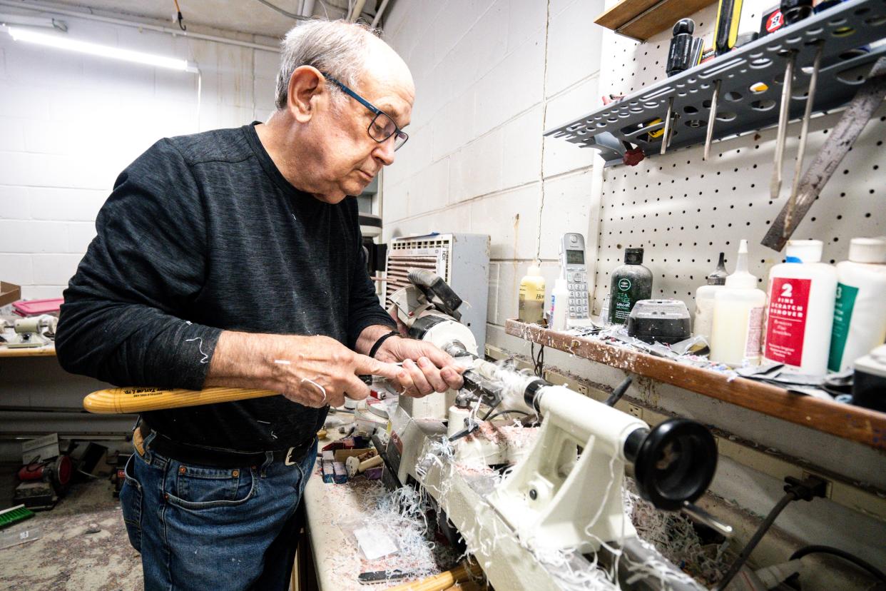 Using a lathe in his backroom workshop at Quill & Nib in Valley Junction, Robert Beers shapes the body of one of his handcrafted pens.