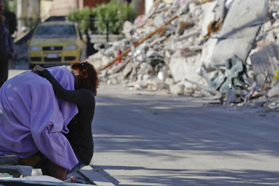 <p>A man and woman comfort each other in front of a collapsed house, in Amatrice, Aug. 26, 2016. Rescue crews have raced against time since a devastating earthquake leveled three towns in central Italy last Wednesday Aug. 23, leaving hundreds dead. (AP Photo/Andrew Medichini) </p>