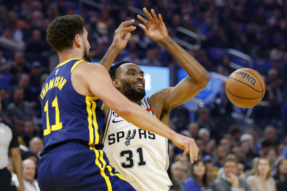 San Antonio Spurs forward Keita Bates-Diop (31) is defended by Golden State Warriors guard Klay Thompson (11) during the first half of an NBA basketball game in San Francisco, Friday, March 31, 2023. (AP Photo/Jed Jacobsohn)