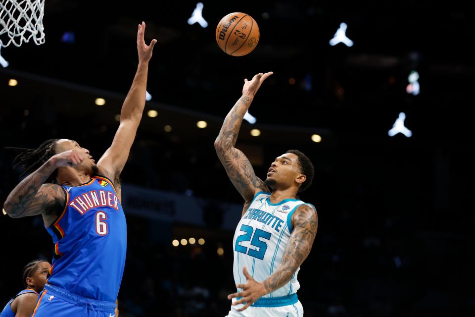 Oct 15, 2023; Charlotte, North Carolina, USA; Charlotte Hornets forward P.J. Washington (25) shoots over Oklahoma City Thunder forward Jaylin Williams (6) in the second half at Spectrum Center. Mandatory Credit: Nell Redmond-USA TODAY Sports