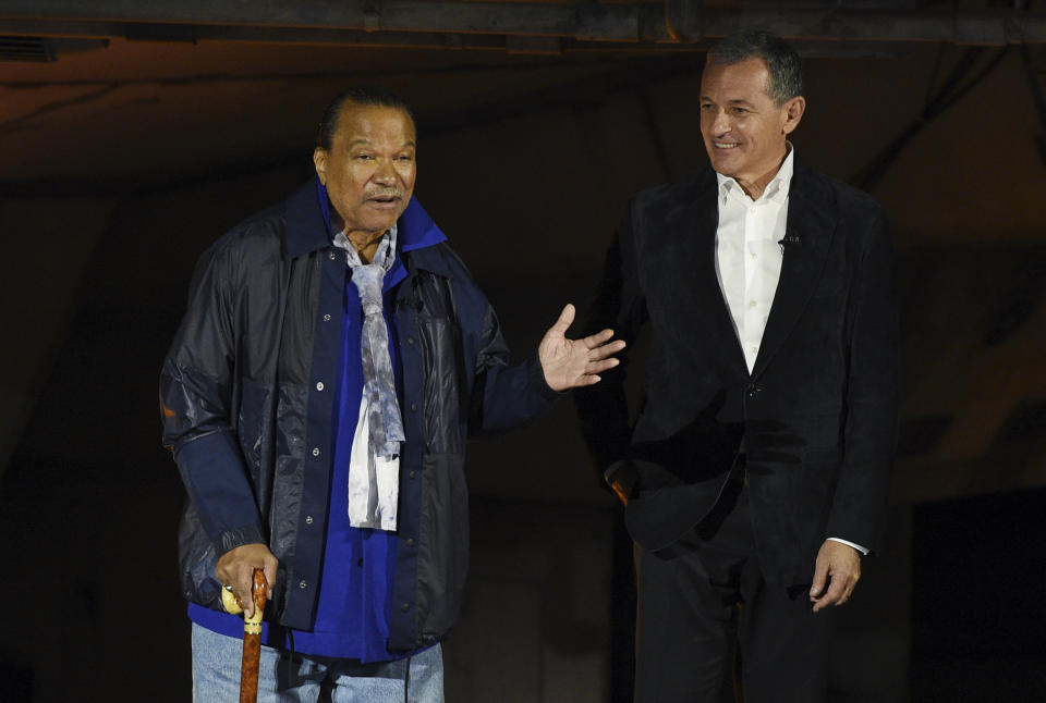 "Star Wars" film franchise cast member Billy Dee Williams, left, addresses the crowd as Walt Disney Co. Chairman and CEO Bob Iger looks on during a dedication ceremony for the new Star Wars: Galaxy's Edge attraction at Disneyland Park, Wednesday, May 29, 2019, in Anaheim, Calif. (Photo by Chris Pizzello/Invision/AP)