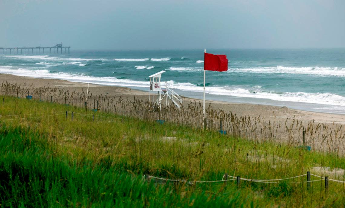 Red flags are displayed along the oceanfront as Tropical Storm Ophelia forms off the coast on Friday morning September 22, 2023, in Emerald Isle, N.C.