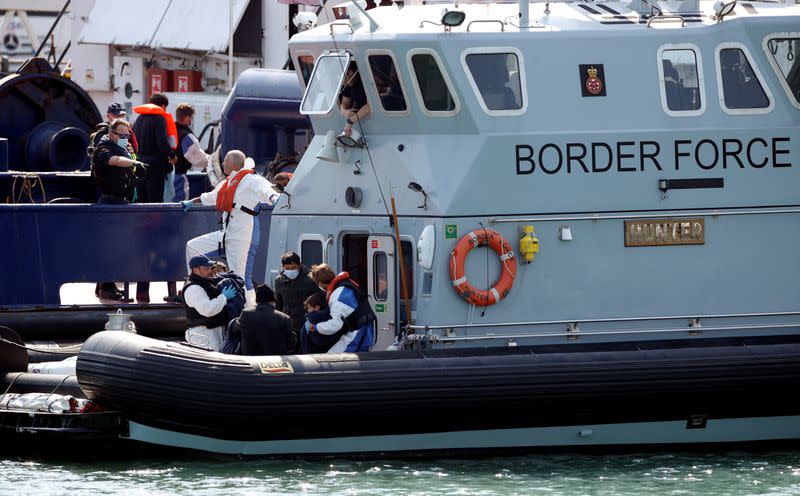 FILE PHOTO: Migrants are seen in the Border Force's boat after arriving at Dover harbour, in Dover